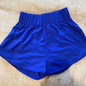 small bright blue high rise halara dolphin shorts